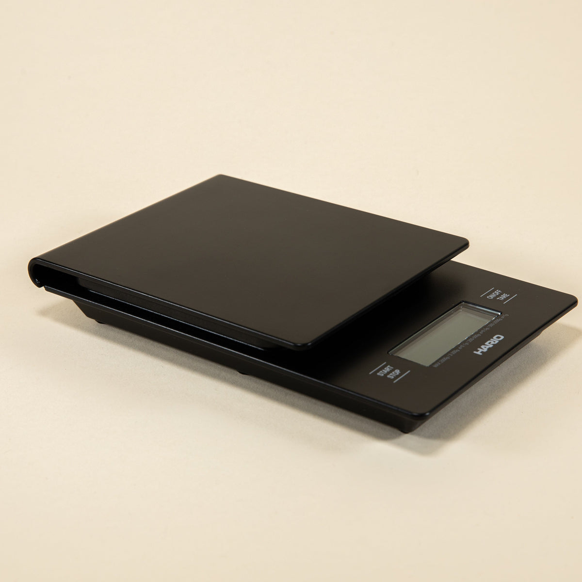Black plastic rectangular shaped scale with digital screen and set against a light background.