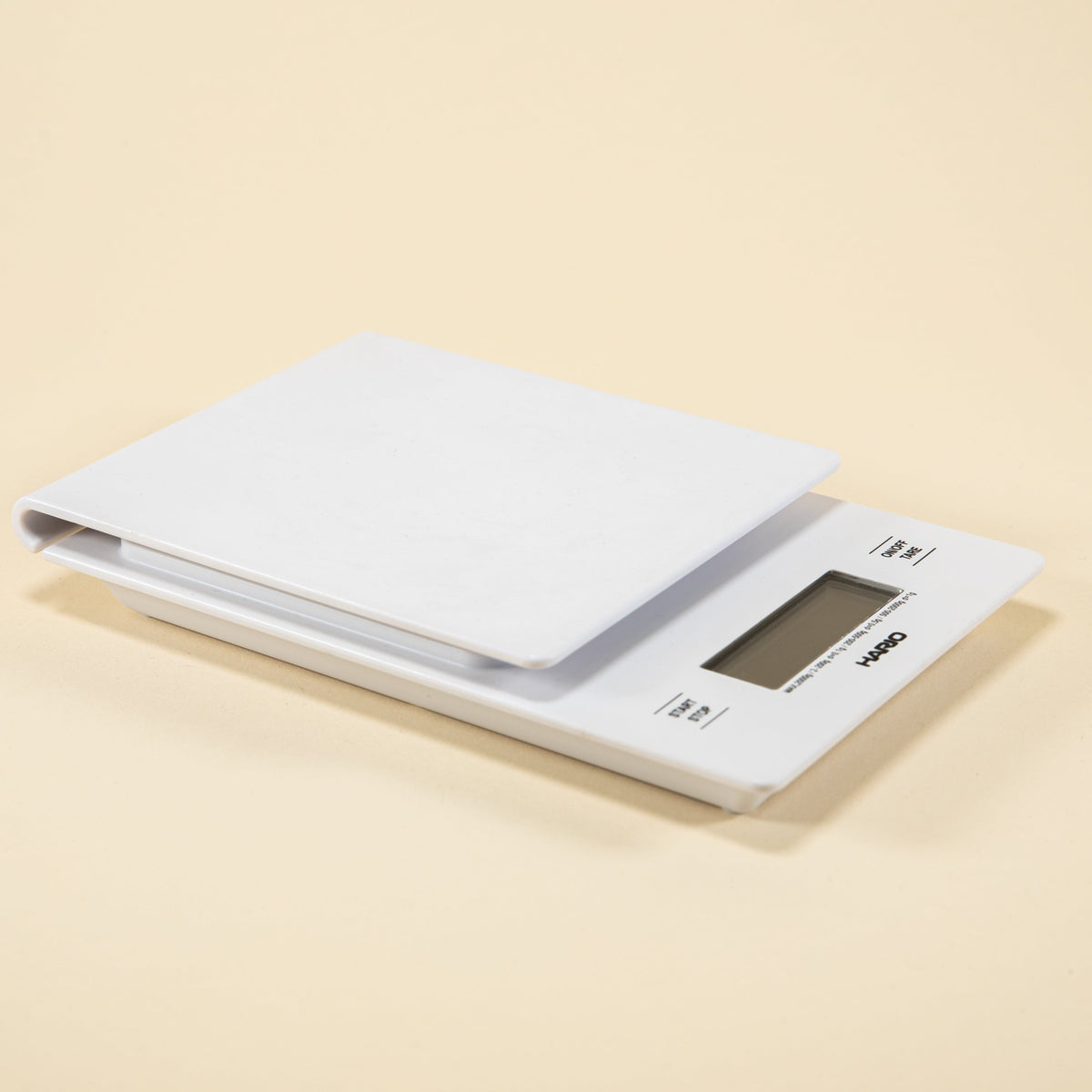 White plastic rectangular shaped scale with digital screen and set against a light background.