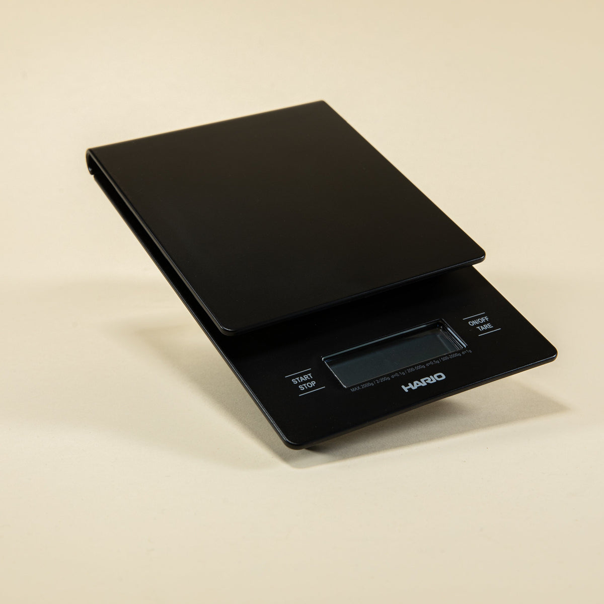 Black plastic rectangular shaped scale with digital screen and set against a light background.