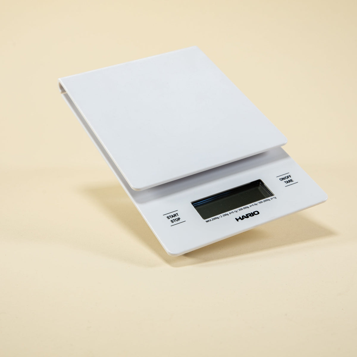 White plastic rectangular shaped scale with digital screen and set against a light background.