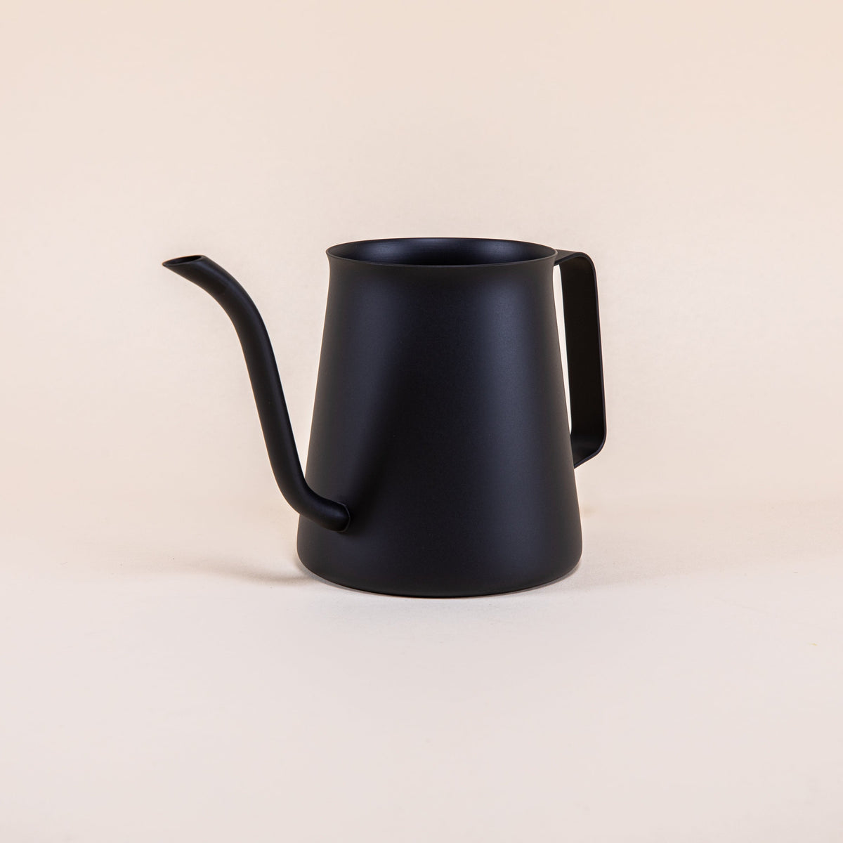 All black metal kettle with flared top, gooseneck spout, and handle on a light background.