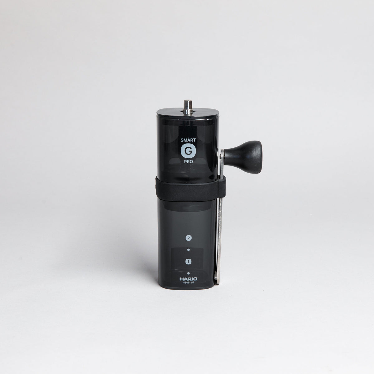Black transparent plastic coffee mill with a slim metal handle and knob attached on side