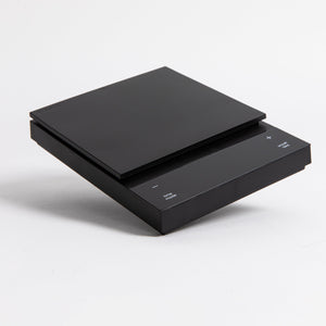 Sleek black digital square scale with a flat surface and clear LED display. set on a white background.