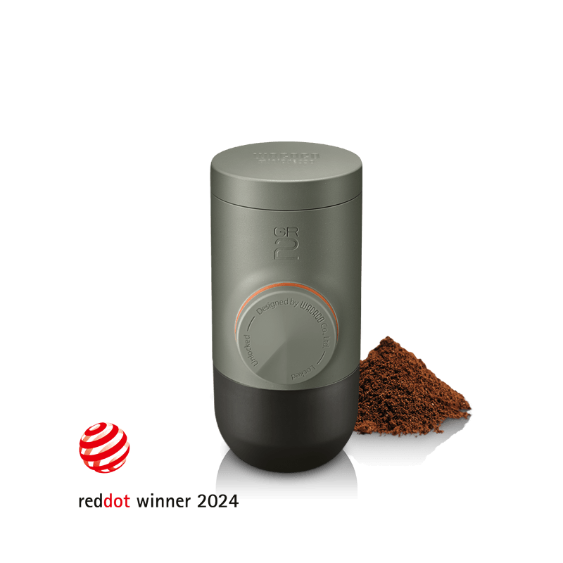 Wacaco Minipresso GR2 portable espresso maker in Olive Green with ground coffee, Red Dot Design Award winner 2024