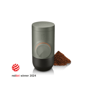 Wacaco Minipresso GR2 portable espresso maker in Olive Green with ground coffee, Red Dot Design Award winner 2024