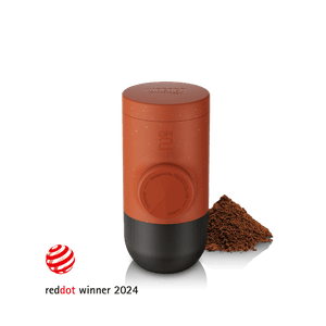 Wacaco Minipresso GR2 portable espresso maker in Tuscan Red with ground coffee, Red Dot Design Award winner 2024